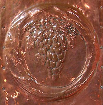Vine motif on the pulpit in beaten copper by Henry Wilson.
