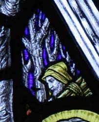Detail of stained glass by Florence Camm showing a woodcutter.