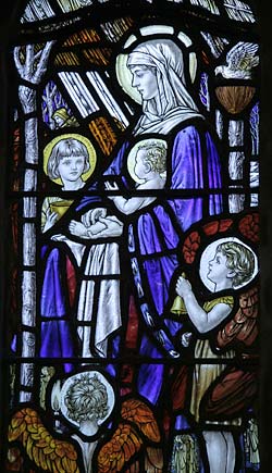 Stained glass window by Florence Camm showing the Virgin and Child with children.